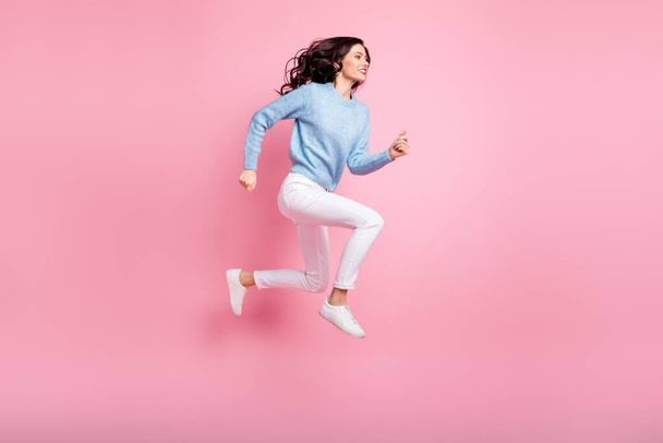 Full length profile photo of funny girl jump run fast wear blue pullover isolated pink color background - Valokuva, kuva