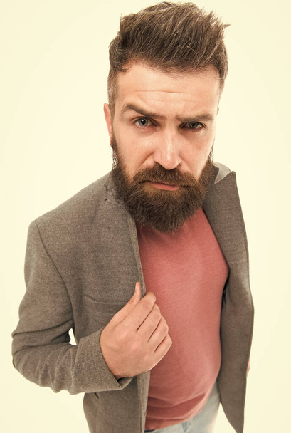 Fashionable and stylish man. Brutal man with long beard and stylish haircut. Caucasian man with mustache and beard hair on unshaven face. Bearded man wearing jeans with jacket - Zdjęcie, obraz