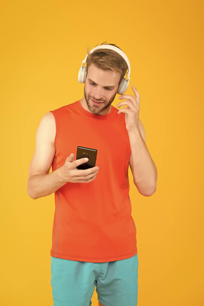 happy young man athlete in sport wear and headset listen music from phone playlist while exercising, ativity - Φωτογραφία, εικόνα