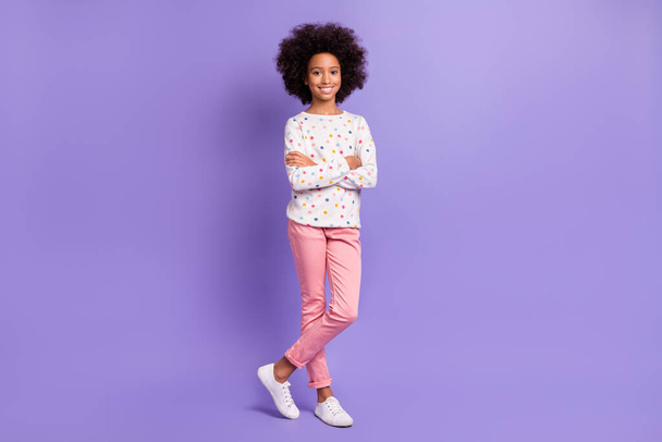 Full length photo of small afro american girl folded hands good mood isolated on purple color background - Foto, afbeelding
