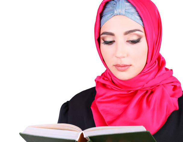 Beautiful muslim arabic woman reading book on grey background - Foto, immagini