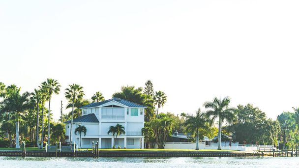 Luxurious house surrounded by palm trees on intercoastal waterway  - Photo, Image
