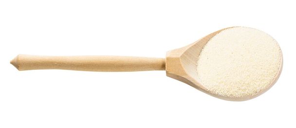 dřevěná lžíce s tepelně neupravené měkké pšenice manna krupice izolované na bílém pozadí - Fotografie, Obrázek