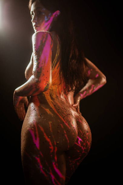 luxurious buttocks, nude model in projector light, cosplay demon on fire - Φωτογραφία, εικόνα