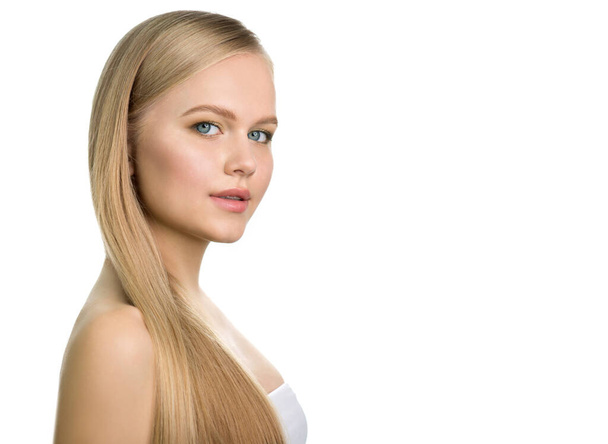 Beautiful young blonde woman with perfect skin and long light blond hair. Portrait of beauty model teen girl with natural make up. SPA, wellness, bodycare and skincare. Isolated on white. - Valokuva, kuva