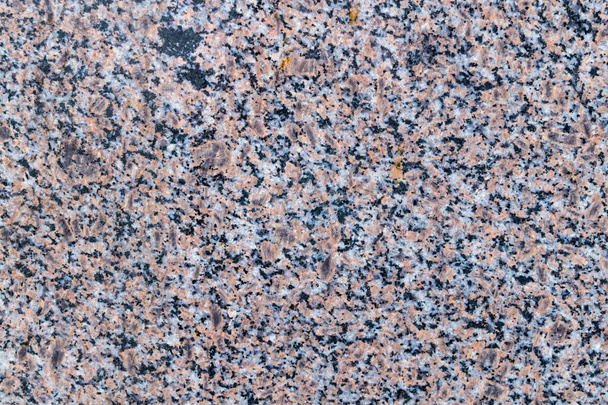 Natuurlijke textuur van grijze en rode granieten steen. Bouwmateriaal - Foto, afbeelding