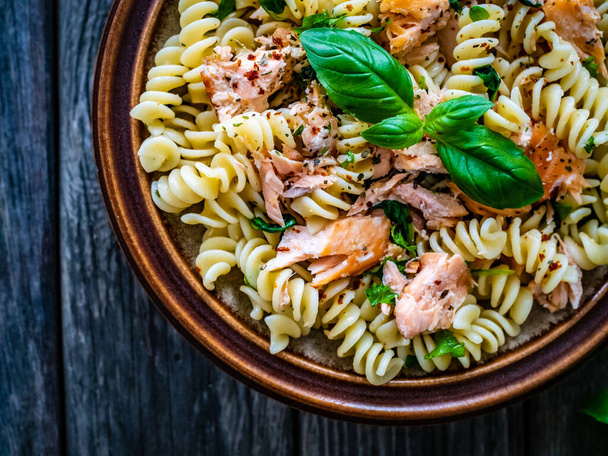 Fusilli with roasted salmon on wooden table  - Fotografie, Obrázek