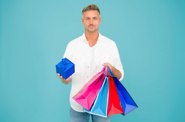 Bachelor day. Black Friday. Cyber monday sale. Retail concept. Happy holidays. Handsome buyer. Free shipping. Mature man hold shopping bags. Seasonal sale. Hipster buying sale price. Birthday gift - Foto, imagen