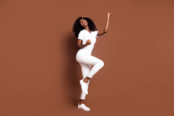Full length body size photo of cool funky model gesturing like lottery winner isolated on pastel brown color background - Zdjęcie, obraz