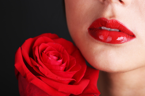 Girl with red lips and rose - Фото, изображение
