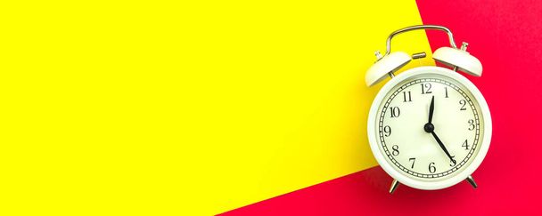 Concept of good morning, banner with white alarm clock on a colorful and bright background, copy space and top view  - Photo, Image