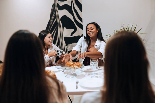Группа женщин-друзей, наслаждающихся едой дома - Фото, изображение
