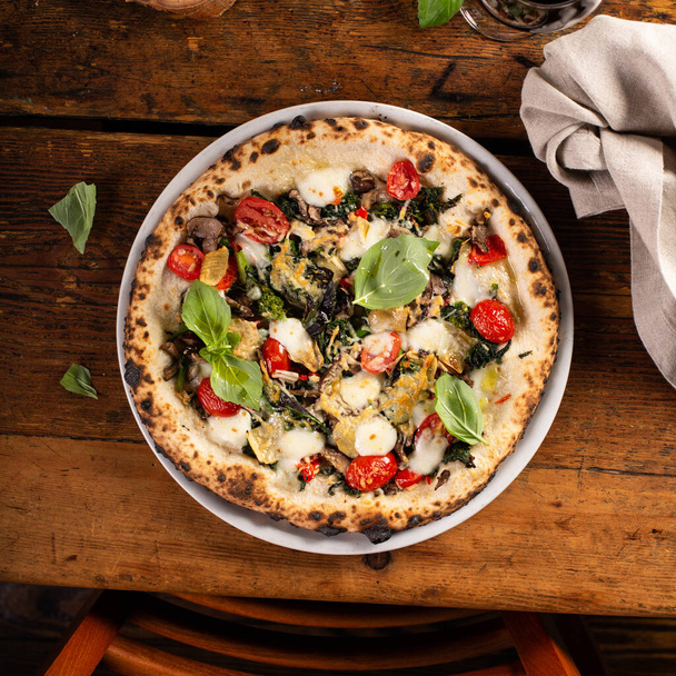Freshly baked vegetarian Neapolitan pizza with mushrooms and artichokes - Photo, Image