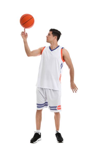 Basketball player spinning ball on finger against white background - Foto, afbeelding