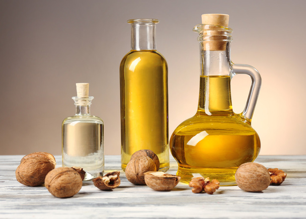 Walnut oil and nuts on wooden table - Zdjęcie, obraz