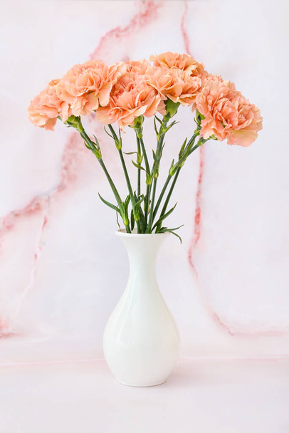 Vase with beautiful carnation flowers on light background - Photo, Image