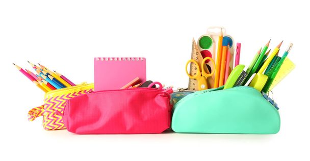 Pencil cases with stationery on white background - Foto, afbeelding