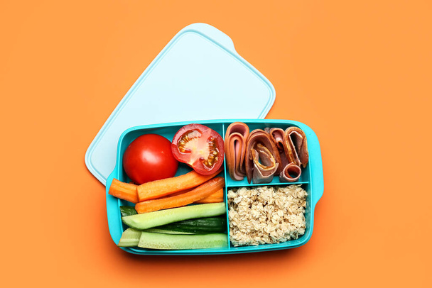 Lunchbox with tasty food on color background - Valokuva, kuva