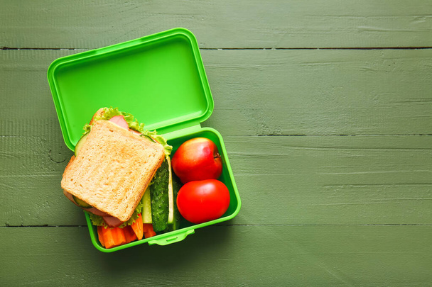 Lunch box with tasty food on wooden background - Photo, Image