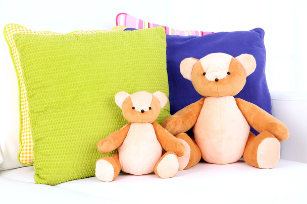 Two bears toy with pillows on sofa - Foto, Bild