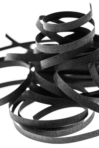A curled black paper ribbons. Abstract artistic patterns. Design concept. Ready solutions for interior design office. Macro lens close up shot 1:1. Monochrome image. - Foto, Imagem