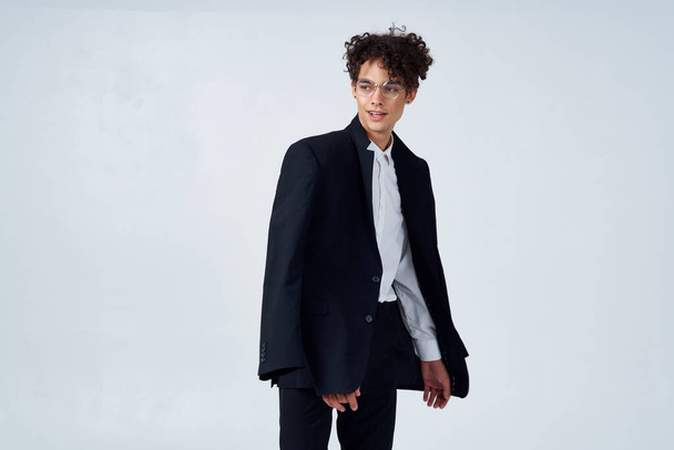 άντρας σε μαύρο σακάκι σγουρά μαλλιά μόδα μοντέρνο στυλ επιχειρηματικό κοστούμι - Φωτογραφία, εικόνα