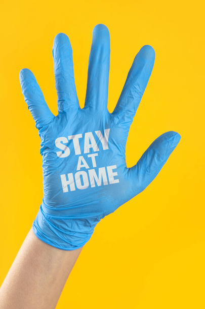 Stay home written on the doctor's hand with surgical glove. Prevent the spread of infectious diseases - Photo, image