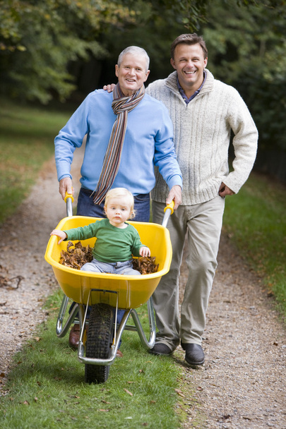 Grandfather and father taking grandson for walk - Foto, Imagen