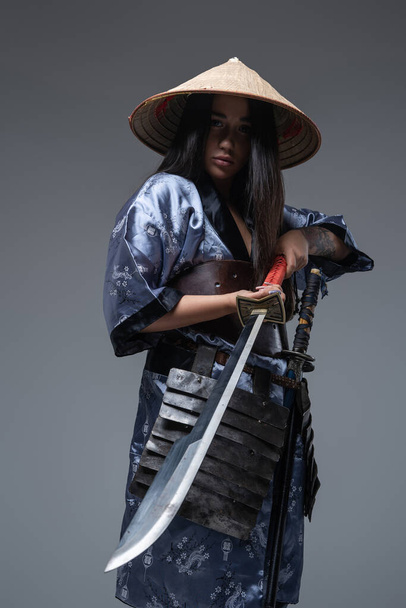 Female samurai with sword and bamboo hat - Fotó, kép