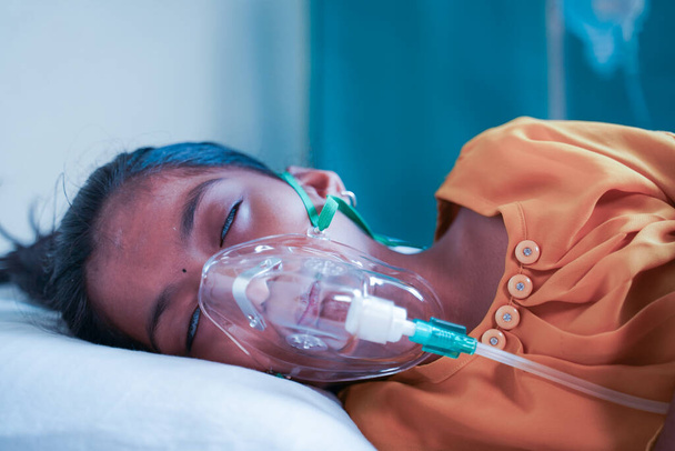 Little Girl kid breathing on ventilator oxygen mask due to coronavirus covid-19 breathing shortness or dyspnea infection - concept of children Healthcare and medical during third wave pandemic outbreak. - Fotó, kép