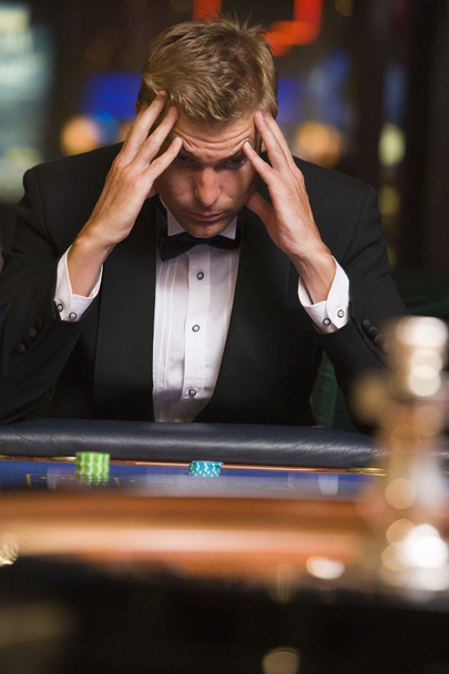 Man losing at roulette table in casino - Photo, image
