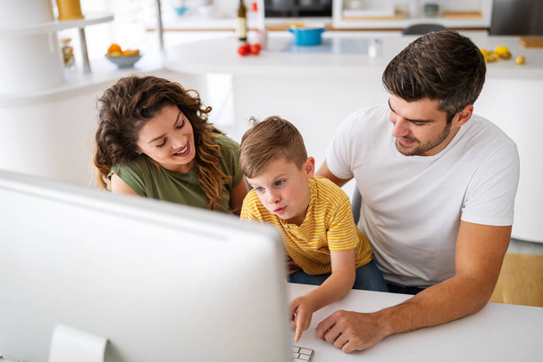 Happy family using technology devices together at home. People, education concept. - Foto, imagen