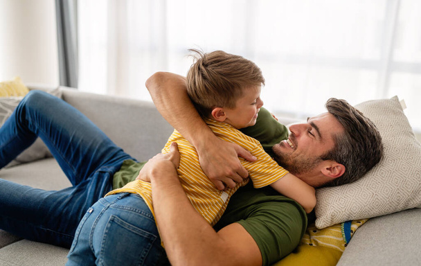 Happy family concept. Handsome father playing with son at home. - Fotoğraf, Görsel