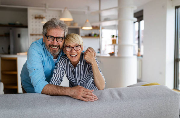 Senior couple in love hugging and bonding with true emotions at home - Φωτογραφία, εικόνα