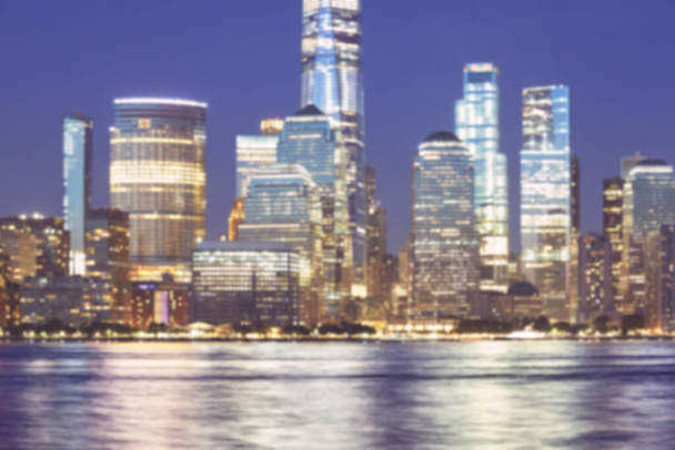 Defocused picture of New York City night skyline, abstract urban background, color toning applied, USA. - Photo, Image