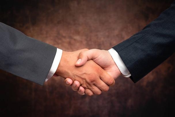 Corporate Businessmen Handshake Indoors.Two People Professionally Well Dressed Gesturing Togetherness.Working Colleague Partners Sign Deal In Agreement To Contract - Photo, Image