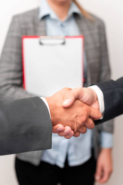 Corporate Businessmen Handshake Indoors.Two People Professionally Well Dressed Gesturing Togetherness.Working Colleague Partners Sign Deal In Agreement To Contract - Fotografie, Obrázek
