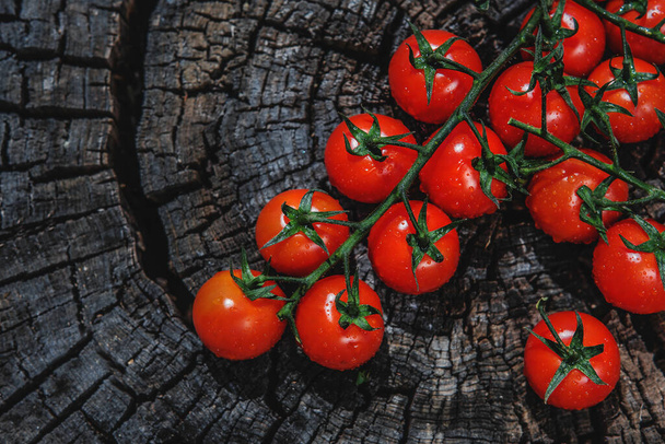 Cherry tomatoes on old wooden surface, space for text. Close up, selective focus. - Photo, image