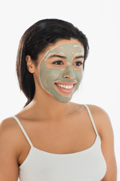 young african american woman with mud mask on face looking away on white background - Foto, imagen