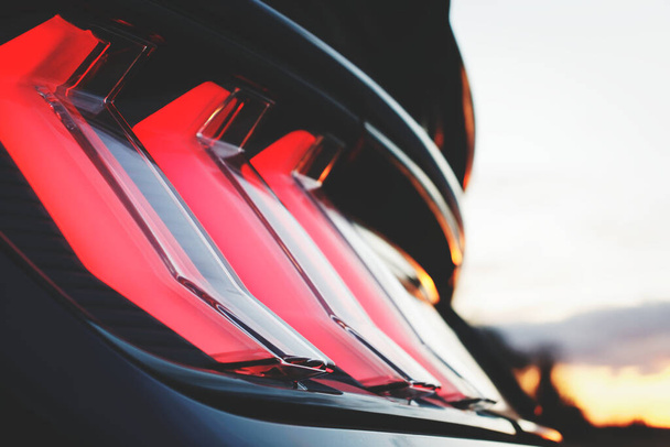 A closeup shot of a black sports car red backlight - Фото, зображення