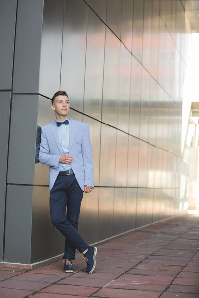 A handsome male with a suit posing outdoors - Photo, Image