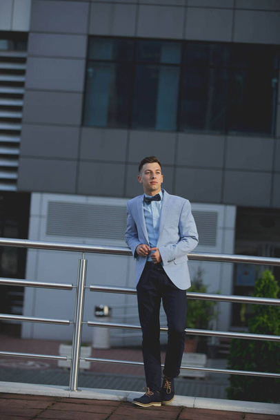 A handsome male with a suit posing outdoors - Photo, image