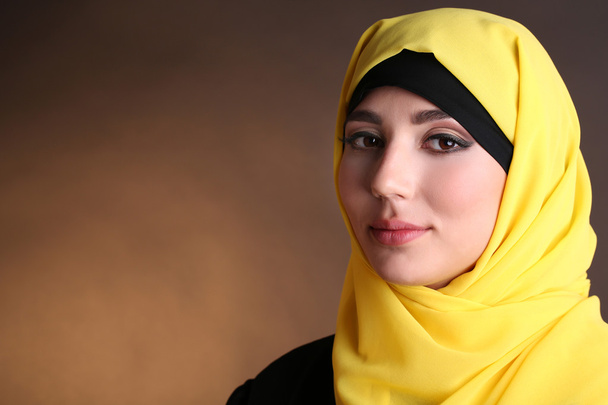 Beautiful muslim arabic woman on dark color background - Valokuva, kuva