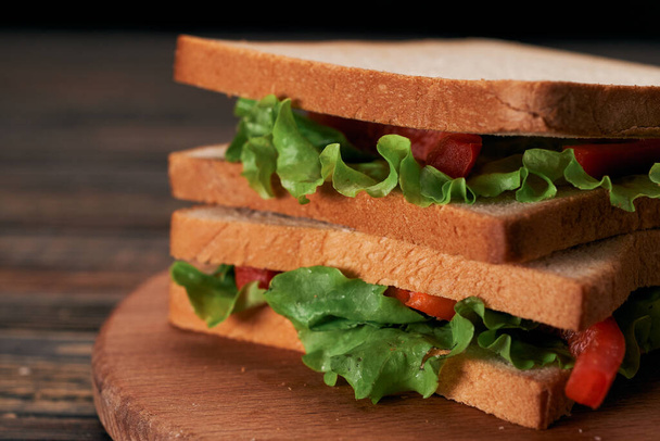 close-up. fresh tomato sandwich on wooden background. - Fotó, kép