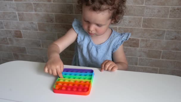 New popular silicone popit toy, baby is playing with it. Development of fine motor skills - Footage, Video