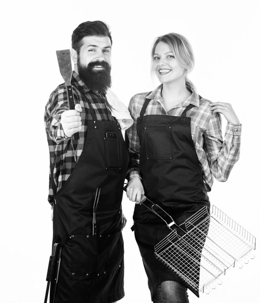Couple in love getting ready for barbecue. Picnic and barbecue. Summertime leisure. Man bearded hipster and girl ready for barbecue white background. Backyard barbecue party. Family bbq ideas - Foto, Imagen