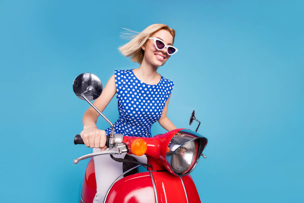 Profile side photo of young cheerful girl happy positive smile ride bike trip travel isolated over blue color background - Valokuva, kuva