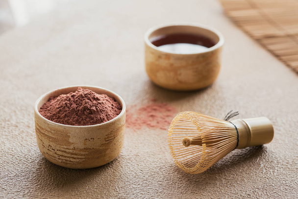 Organic Color powder tea Matcha with Japanese tools bamboo whisk on beige background. Concept Vegetarian healthy drink, beverage - Fotografie, Obrázek