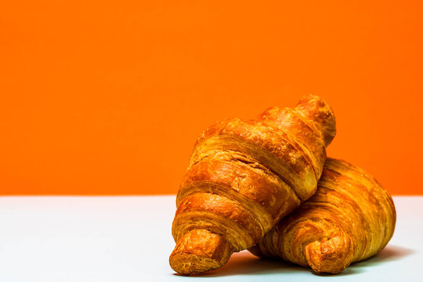 Freshly baked golden brown French croissants. Tasty baked croissants, warm buttery croissants - Photo, Image