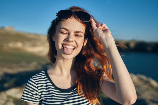 cheerful woman wearing sunglasses mountains outdoors near the sea - Photo, Image